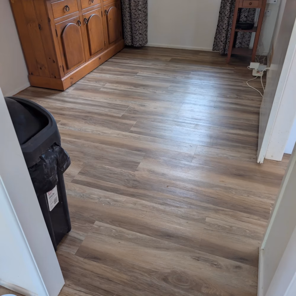 Home office space featuring premium vinyl plank flooring with professional finish